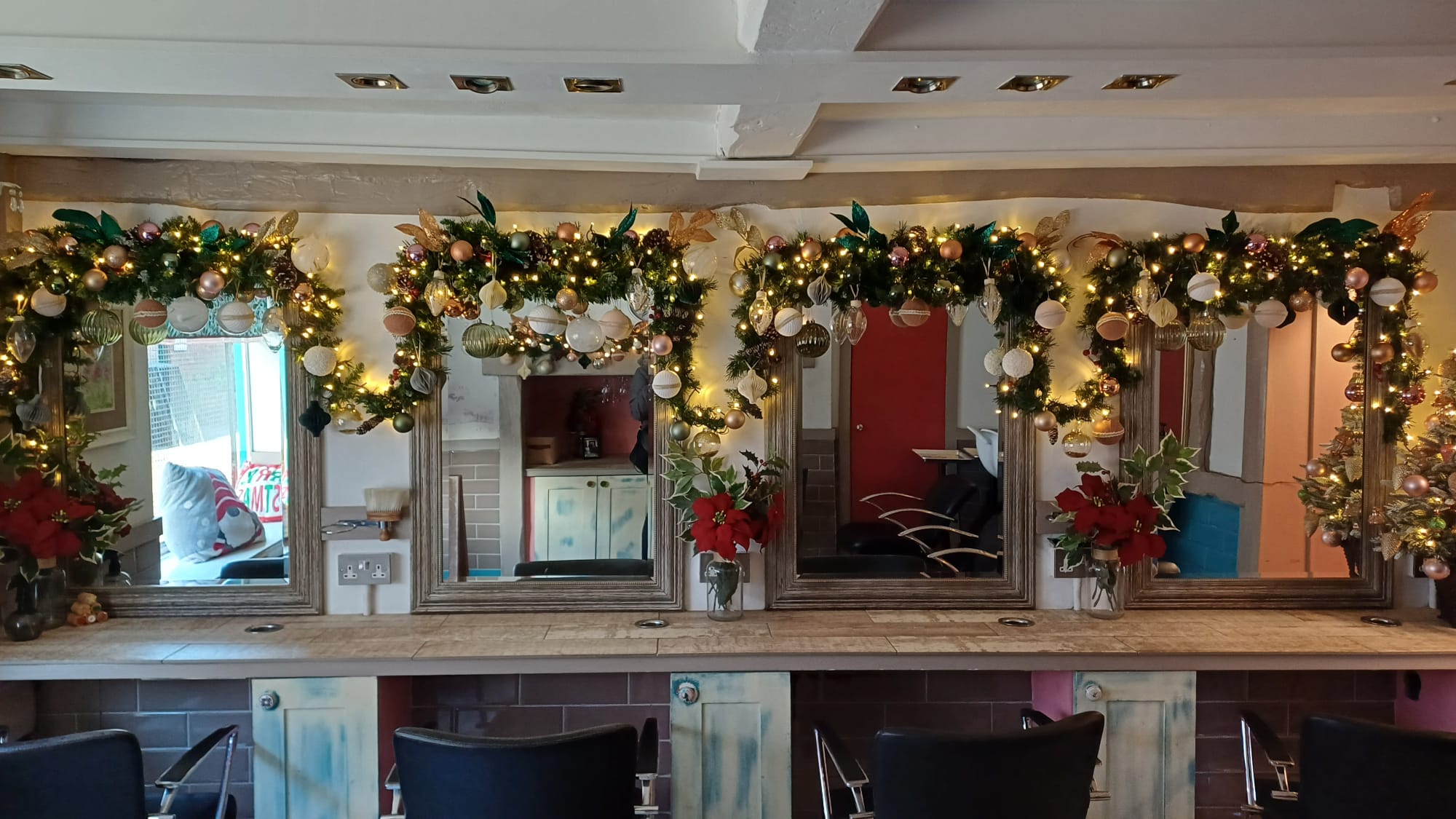A wide view of Howard's End salon decorated with glowing Christmas garlands