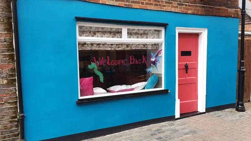 The blue frontage and bright pink door of Howard's End on Middle Row